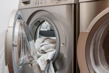 Image of a washing machine, showing the risk presented by doing laundry for people who work in asbestos jobs. Our clients often wonder, "What is secondary asbestos exposure"? This article describes paraoccupational exposure in detail, with examples.