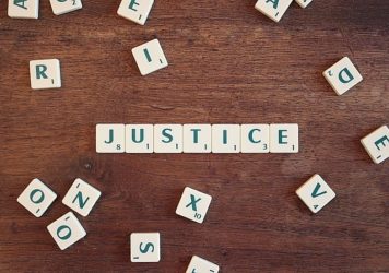 Image of Letter Tiles Spelling the Word Justice, Representing the Individual Elements of Knowledge, Experience, and Compassion that Make Nemeroff Law Firm the Right Asbestos Cancer Attorney to Obtain Justice for You.