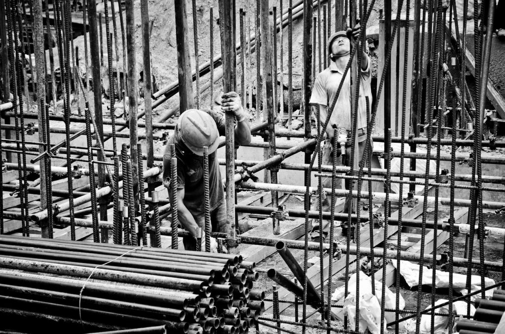 Image of construction workers on a construction site, who may have been exposed to asbestos in construction materials but do not know how much asbestos exposure is harmful. Those diagnosed with mesothelioma, asbestosis, or lung cancer would benefit from consulting Nemeroff Law Firm’s experienced asbestos lawyers, who fight for victims nationwide.